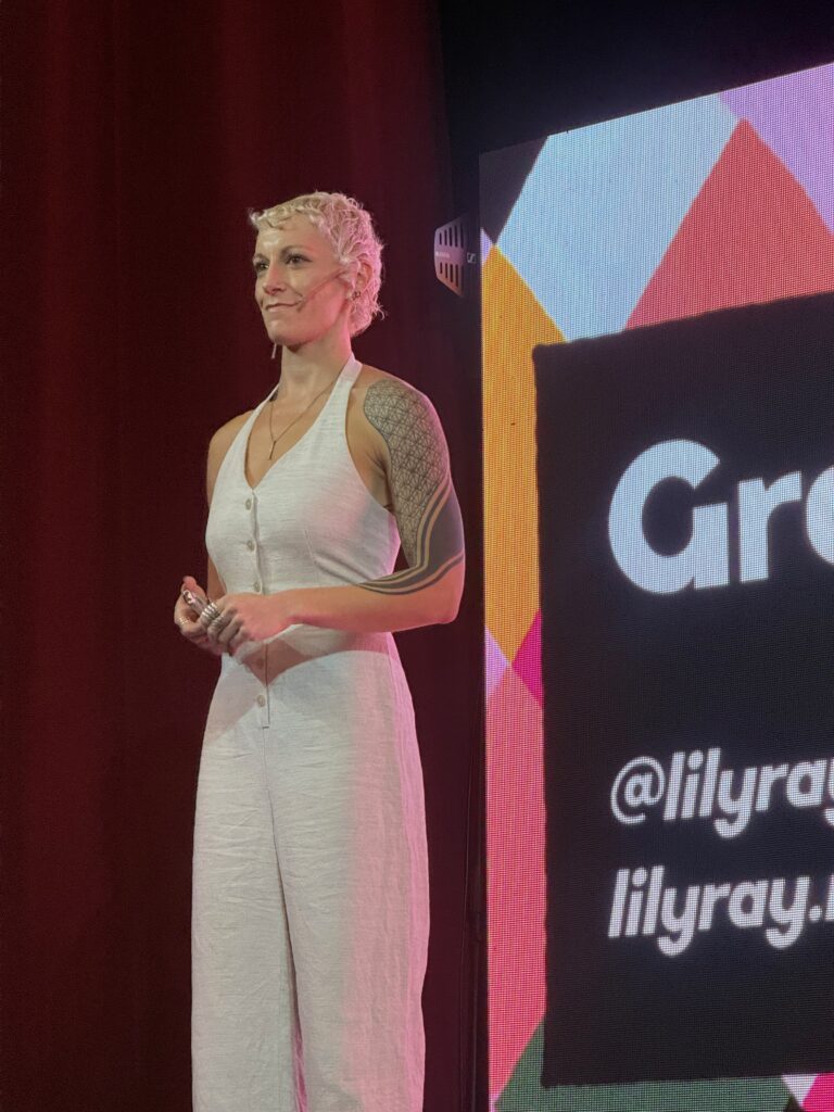 Lily Ray standing confidently on stage